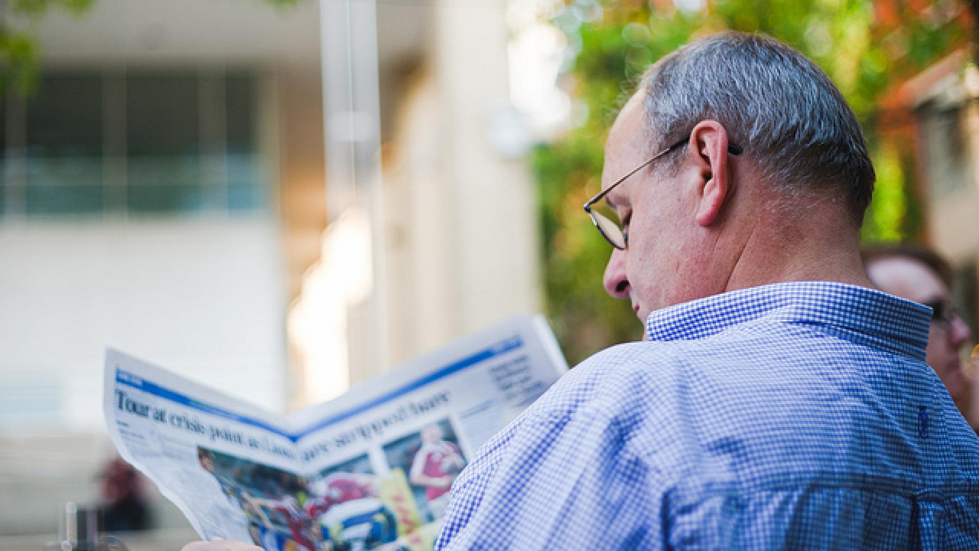 picture of man reading newspaper
