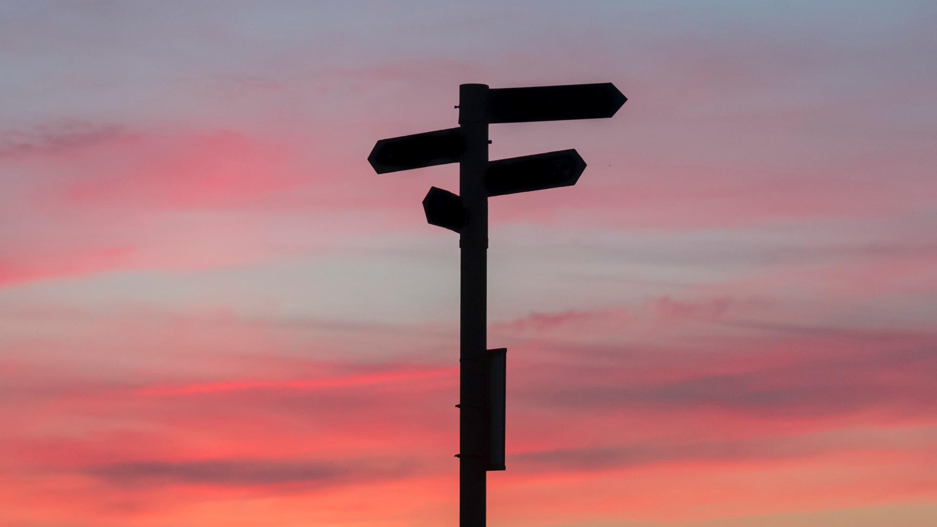 Signpost over a sunset