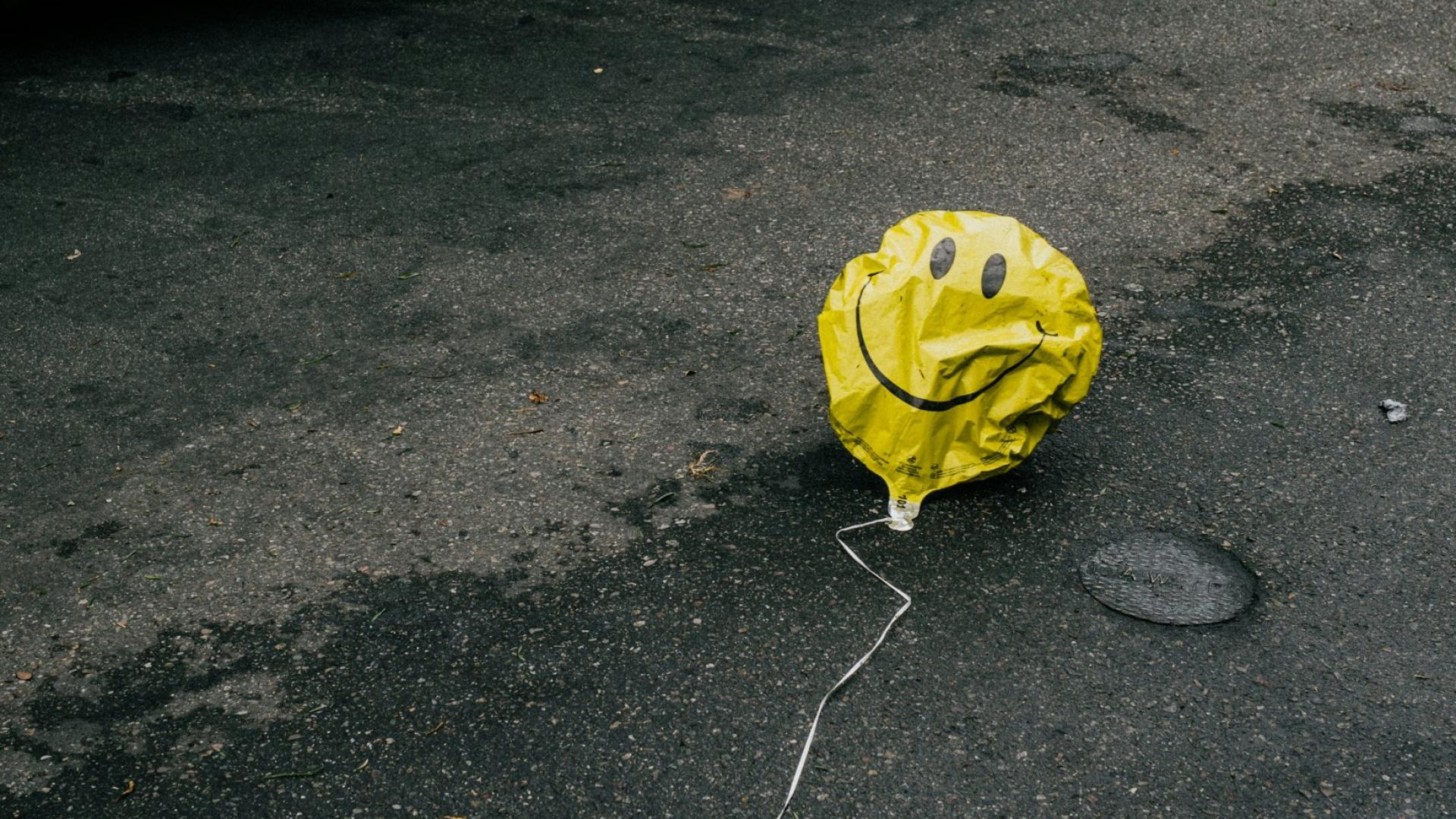 Deflated happy face balloon